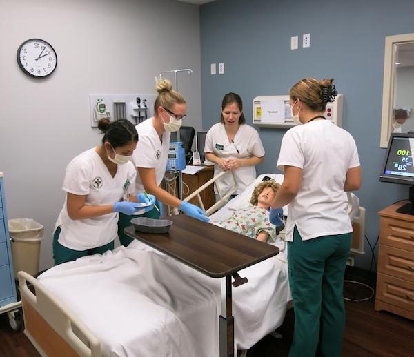 Nursing students working inside a laboratory setting. 